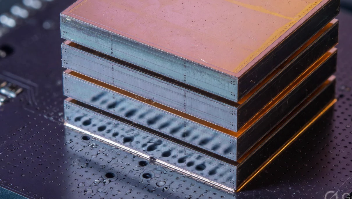 Editorial render of a partner HBM cube stack. Not a pinout.